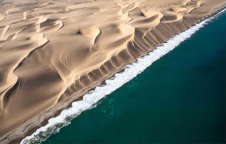 Namib dunes falling into the Atlantic at Sandwich Harbour